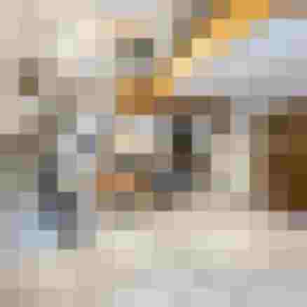 Heller Eingangsbereich mit Treppe, Sitzecke und Kamin im alpinen Stil